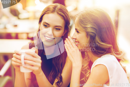 Image of young women drinking coffee and talking at cafe