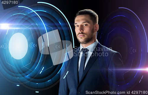 Image of businessman in suit over black