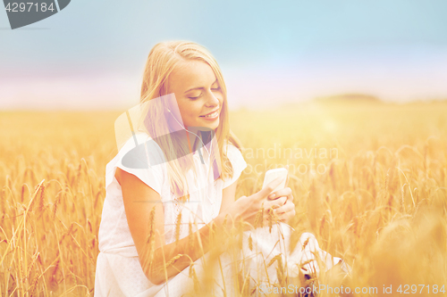 Image of happy woman with smartphone and earphones
