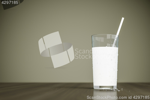 Image of a glass of milk with a straw