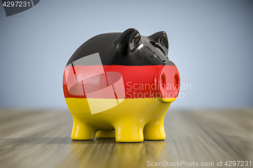 Image of fat piggy bank in german colors