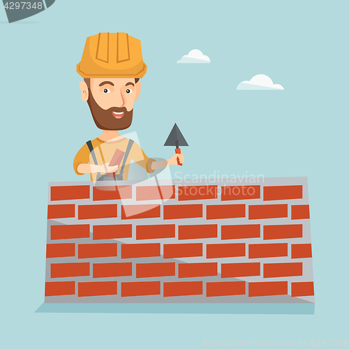 Image of Bricklayer working with spatula and brick.