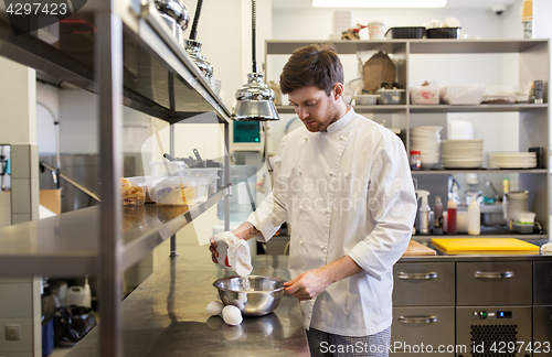 Image of happy male chef cooking food at restaurant kitchen