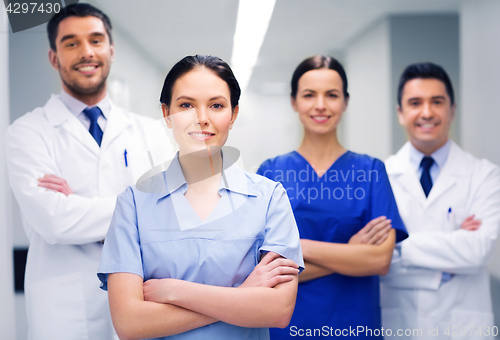 Image of happy group of medics or doctors at hospital