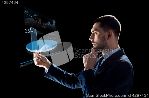 Image of businessman with tablet pc and virtual charts