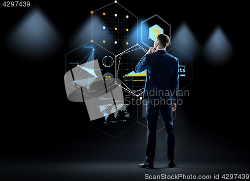 Image of businessman looking at virtual screen from back