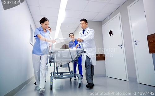 Image of medics and patient on hospital gurney at emergency