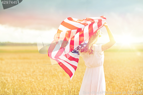 Image of happy woman with american flag on cereal field