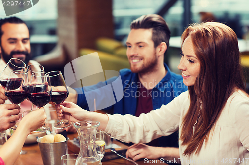 Image of friends dining and drinking wine at restaurant