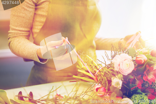 Image of close up of woman making bunch at flower shop