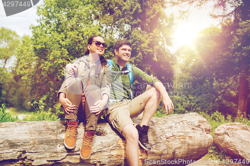 Image of smiling couple with backpacks in nature