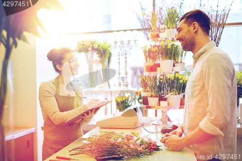 Image of florist woman and man making order at flower shop