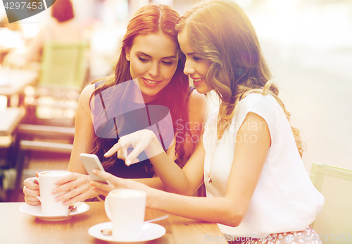 Image of young women with smartphone and coffee at cafe