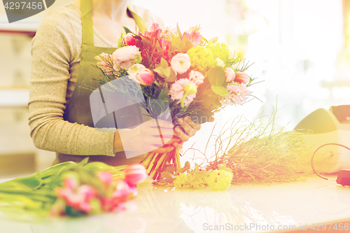 Image of close up of woman making bunch at flower shop