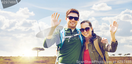 Image of smiling couple with backpacks traveling in africa