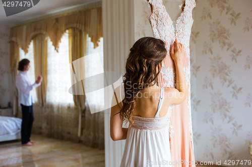 Image of Bride hugging wedding dress