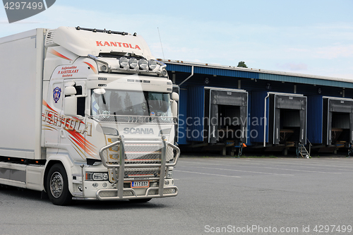 Image of White Scania Refrigerated Transport Truck at Warehouse Yard