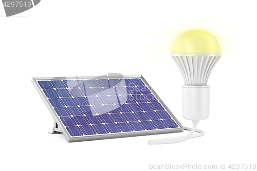 Image of Solar panel and glowing light bulb