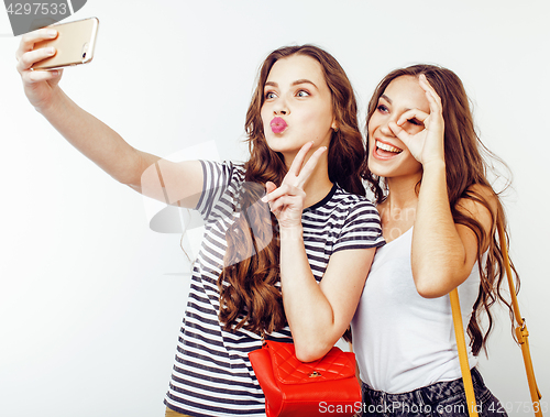 Image of best friends teenage girls together having fun, posing emotional on white background, besties happy smiling, lifestyle people concept close up. making selfie