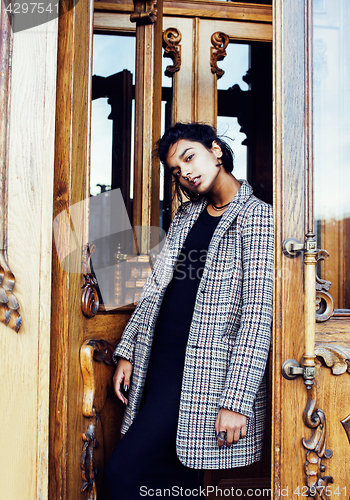 Image of young pretty student teenage indian girl in doors happy smiling,