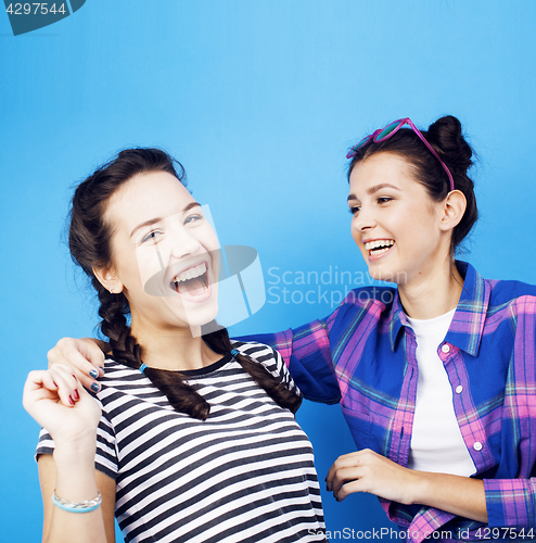 Image of best friends teenage school girls together having fun, posing on blue background, besties happy smiling, lifestyle people concept