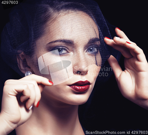 Image of beauty brunette woman under black veil with red manicure close u