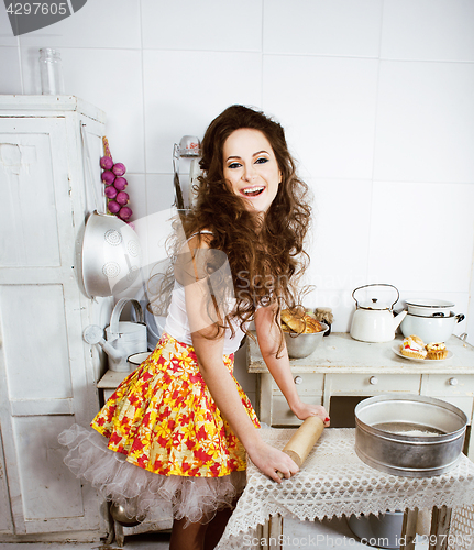 Image of crazy real woman housewife on kitchen, eating perfoming, bizare 