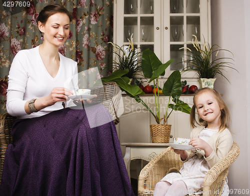 Image of young mother with daughter at luxury home interior vintage