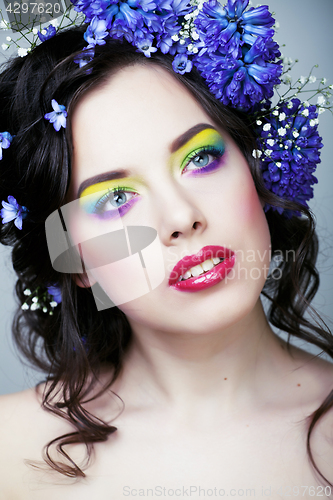 Image of Beauty young woman with flowers and make up close up, real sprin