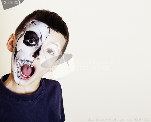 Image of little cute boy with facepaint like skeleton to celebrate hallow