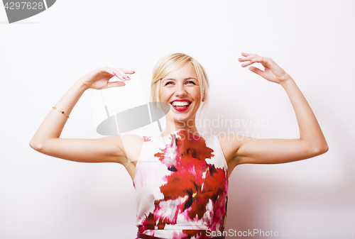 Image of young pretty blonde girl presenting something at white copy spac