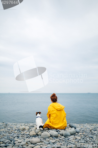 Image of Woman with dog on coast