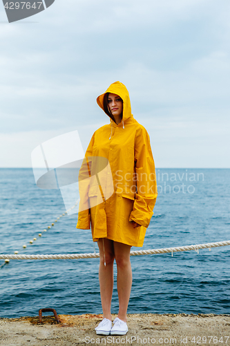 Image of Girl wearing yellow raincoat