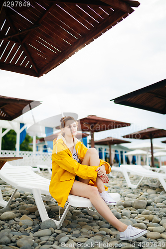 Image of Girl posing on pebble beach