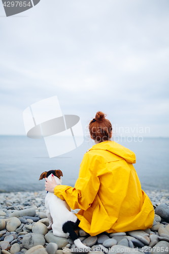 Image of Woman with dog on coast