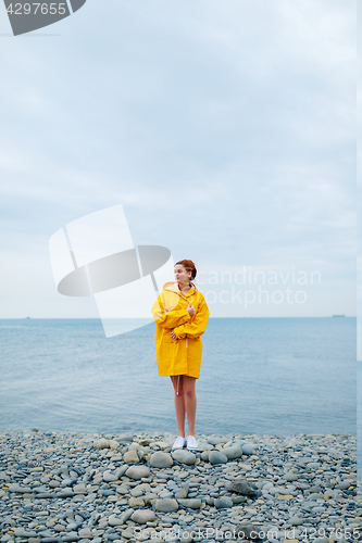 Image of Girl wearing yellow raincoat