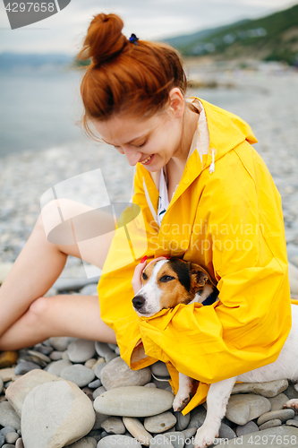 Image of Girl with dog on beach