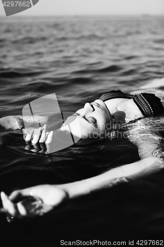 Image of Woman floating on water