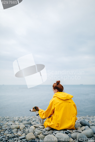 Image of Woman with dog on coast