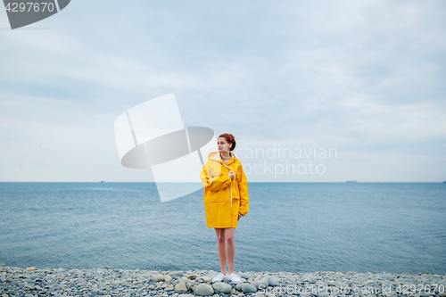 Image of Girl wearing yellow raincoat