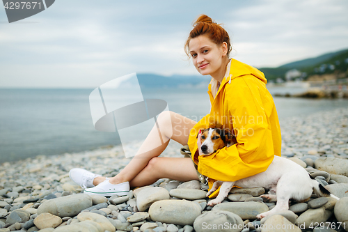 Image of Girl with dog on beach