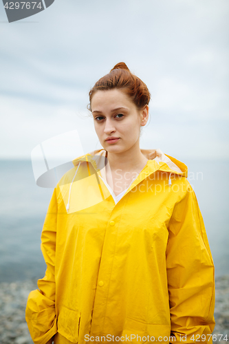 Image of Girl wearing yellow raincoat