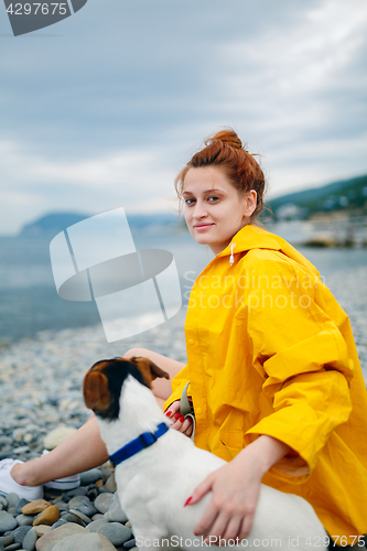 Image of Girl with dog on beach