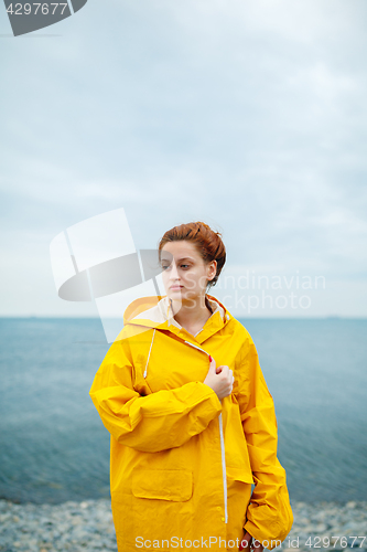 Image of Girl wearing yellow raincoat