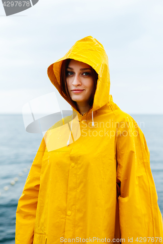 Image of Girl wearing yellow raincoat