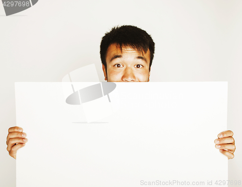 Image of pretty cool asian man holding empty white plate smiling