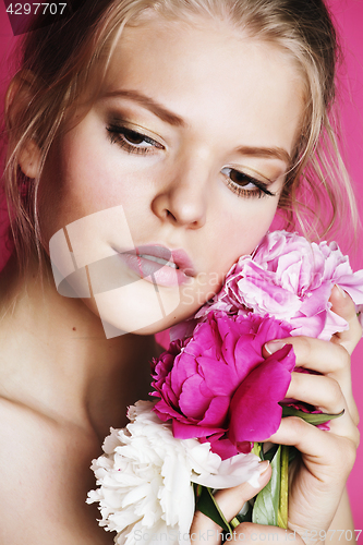 Image of young beauty woman with flower peony pink closeup makeup soft te