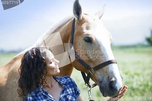 Image of Woman and horse together at paddock