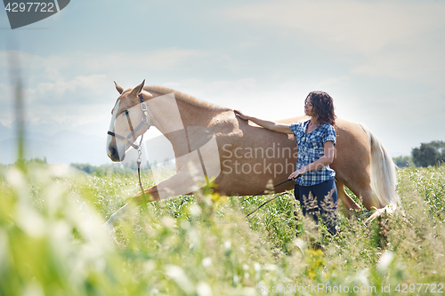 Image of Woman training her horse