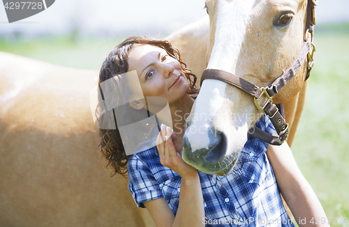 Image of Woman and horse together at paddock